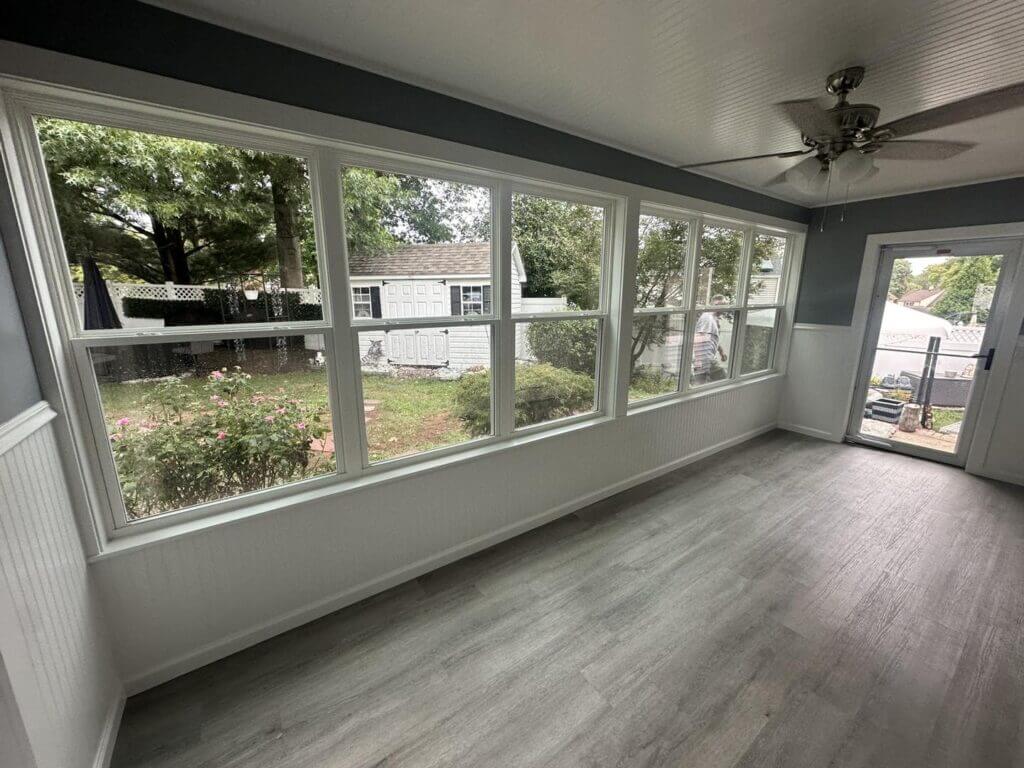Sunroom with a continuous run of windows overlooking the backyard