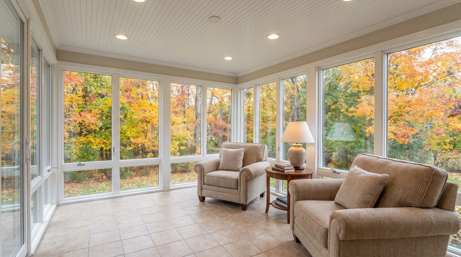 Three-season porch enclosure with glass panel windows and a tile floor in New Jersey