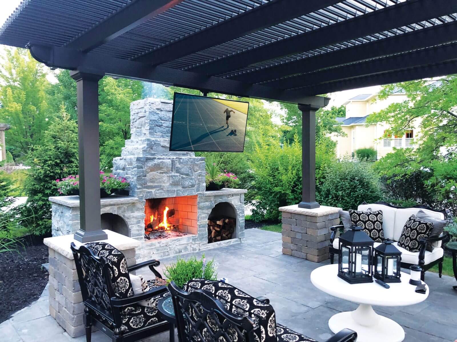Freestanding bronze pergola over a hardscape patio in New Jersey